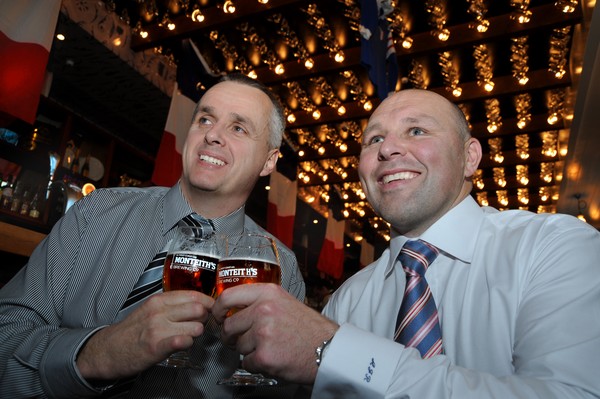 NZ Spinal Trust's Andrew Hall (left) and The Flying Moa's Andy Roberts celebrate the success of the fundraising luncheon with a Monteith's in hand.